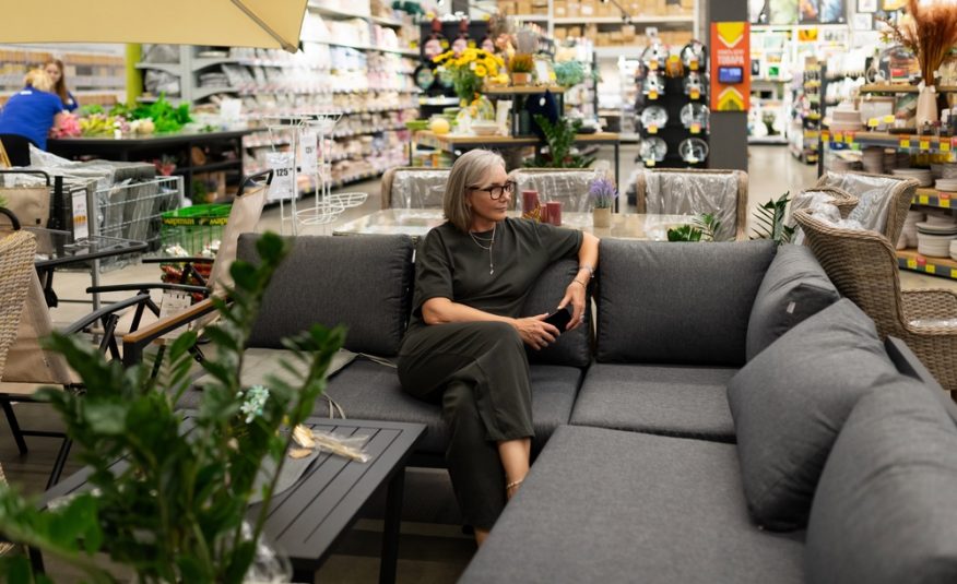 A,Woman,Sits,Comfortably,On,A,Stylish,Sofa,,Thoughtfully,Choosing